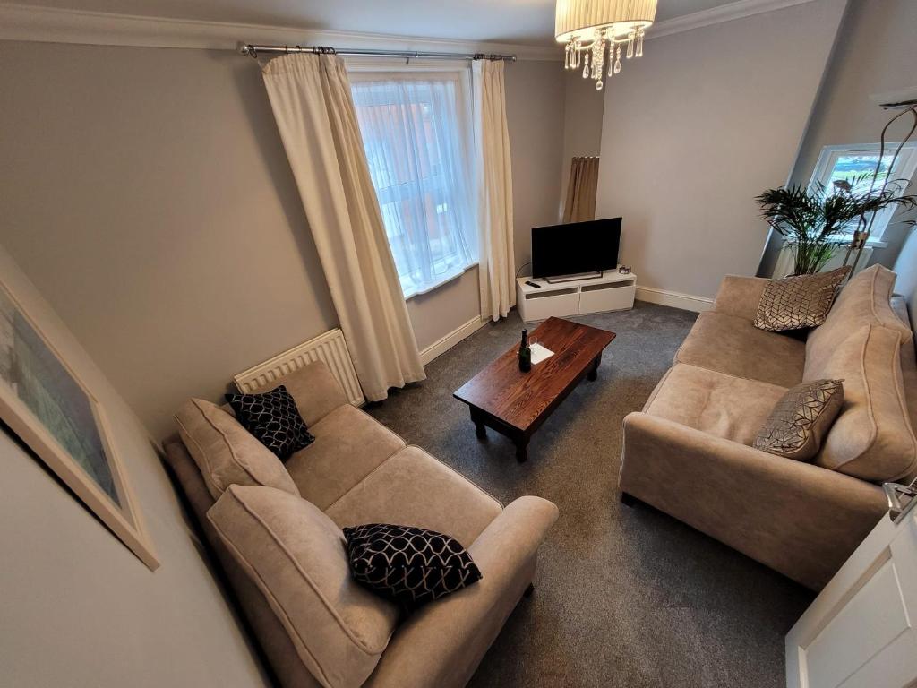 a living room with two couches and a tv at 39 Queens Road in Swanage