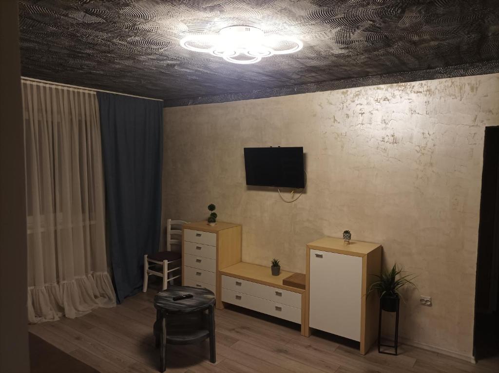 a room with a desk and a tv on the wall at Centrul Vechi Aparthotel in Brăila