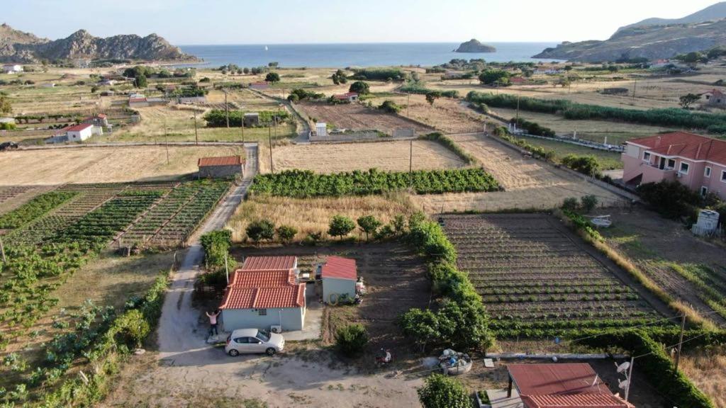 an aerial view of a farm with a van parked in a field at MANOLIS COTTAGE THANOS in Thános