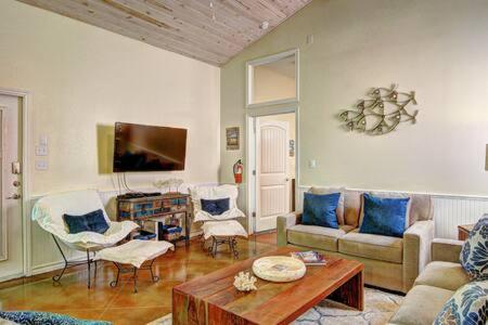 a living room with a couch and a table at Crane's Landing at Pirates Bay in Port Aransas