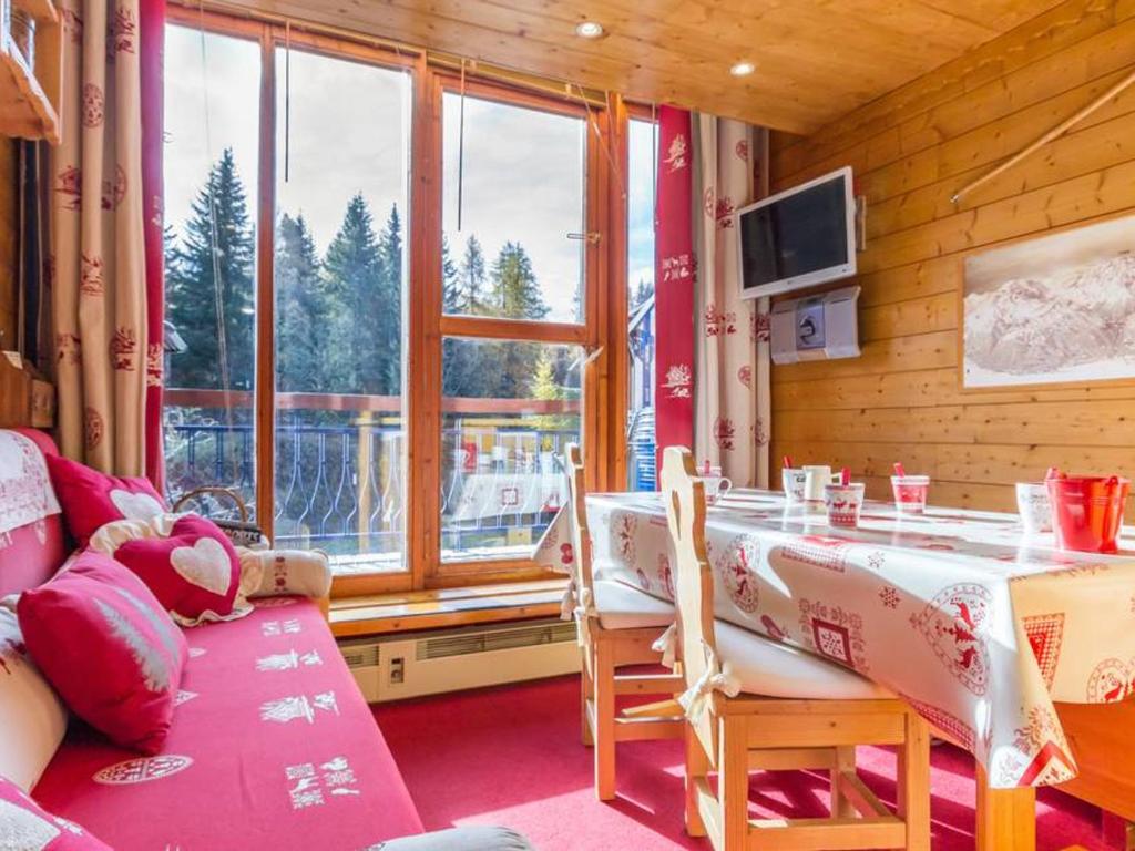 a dining room with a table and a large window at Appartement Les Arcs 1800, 2 pièces, 6 personnes - FR-1-346-412 in Arc 1800
