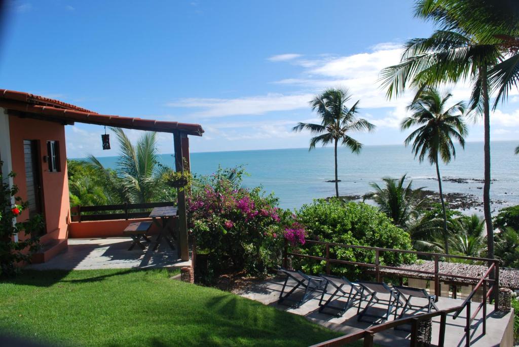 a view of the ocean from the balcony of a house at Pousada Da Luz Carapibus in Jacumã