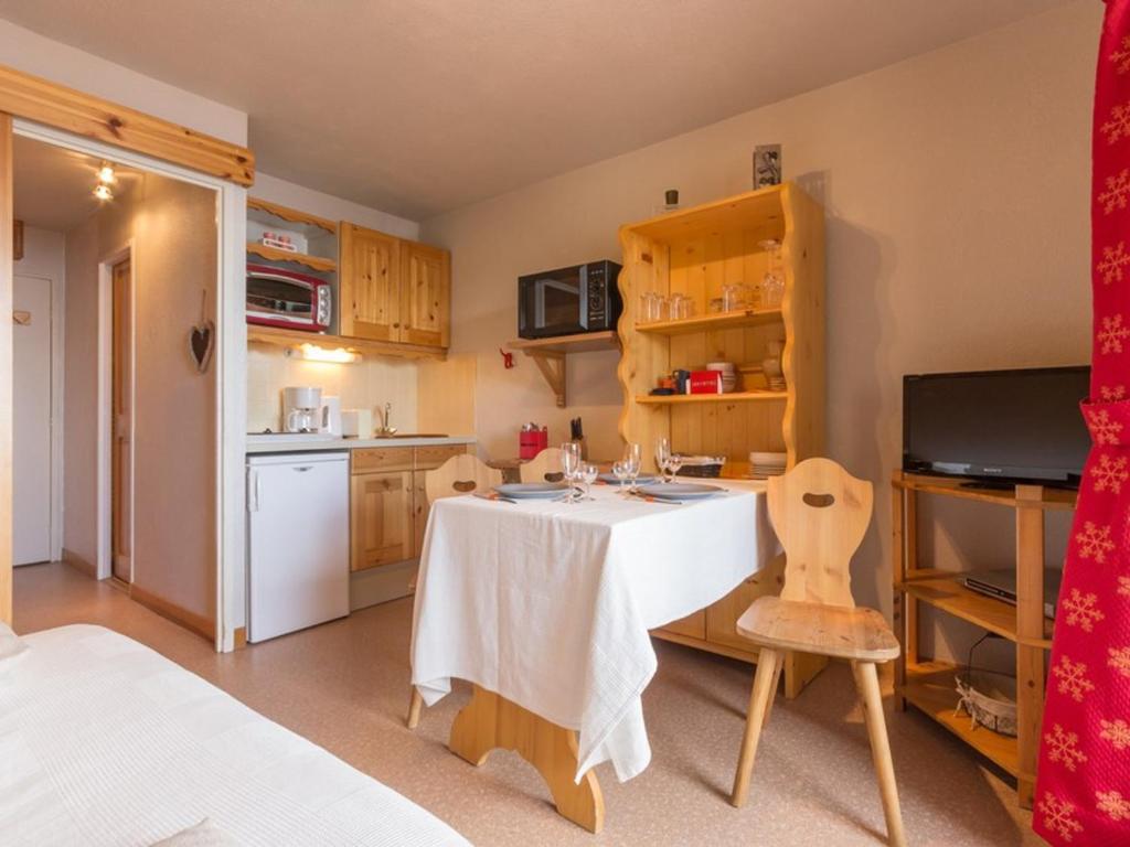 a small kitchen with a table in a room at Studio La Rosière, 1 pièce, 4 personnes - FR-1-275-144 in La Rosière