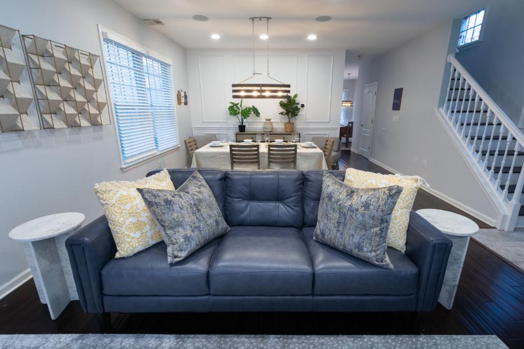 a living room with a blue couch and a table at Luxury Beachside Vacation Getaway - OceanView, Movie Theatre, Mini Golf in Atlantic City