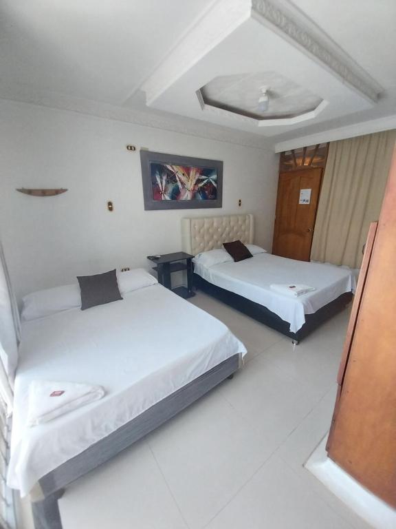 Postel nebo postele na pokoji v ubytování Hotel Sierra Nevada B&B SAS