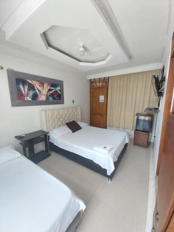 Postel nebo postele na pokoji v ubytování Hotel Sierra Nevada B&B SAS