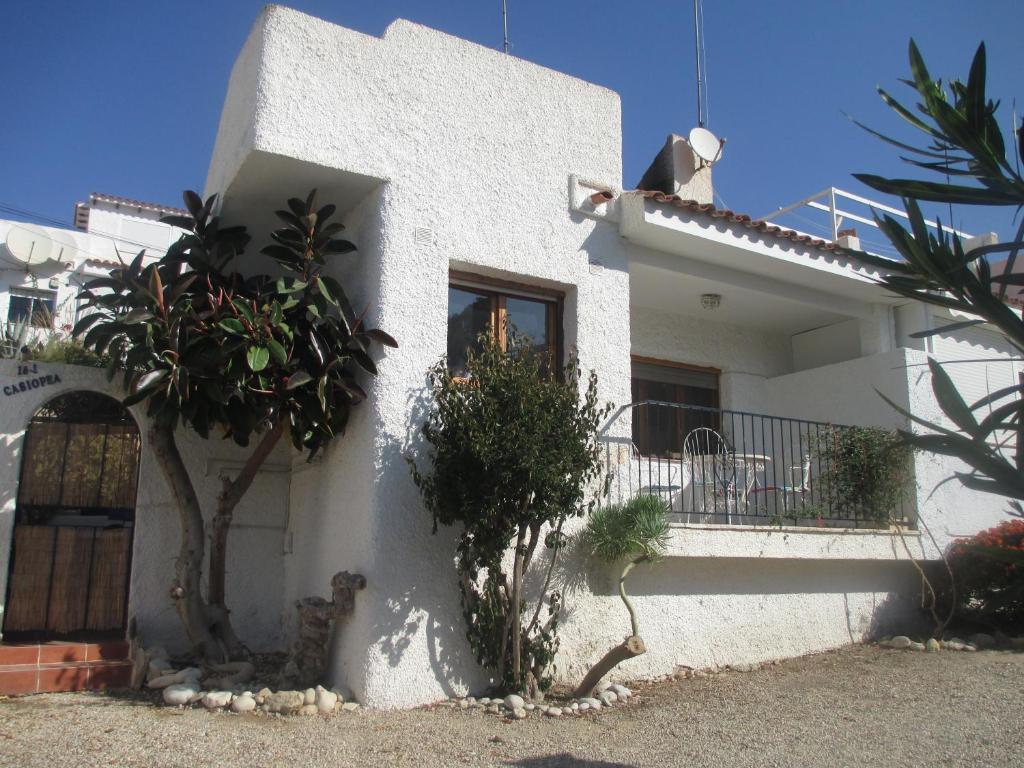 a white house with a tree and a balcony at Bungalow CASIOPEA Internet 300 Mb SAT SMARTTV in El Campello