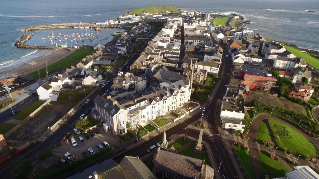 an aerial view of a town next to the ocean at Antrim House Guest Rooms & Suites in Portrush