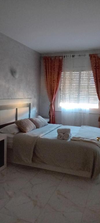 um quarto com uma cama grande e uma janela em Apartamento vacaciones em Palafrugell