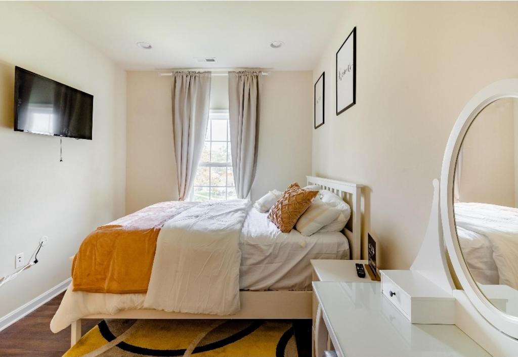 a bedroom with a bed and a mirror at Luxurious and Peaceful Room in Washington DC in Washington, D.C.