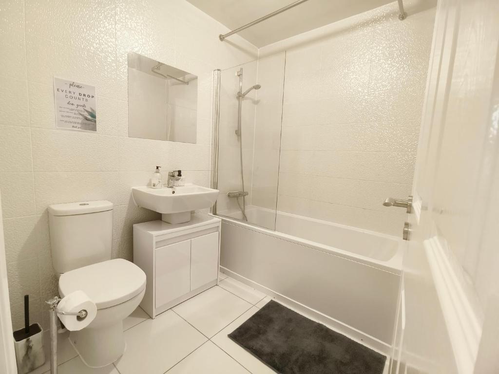 ein weißes Badezimmer mit Toilette und Waschbecken in der Unterkunft Shared House - 10 mins from Piccadilly Station/Man Uni/O2 Apollo in Manchester