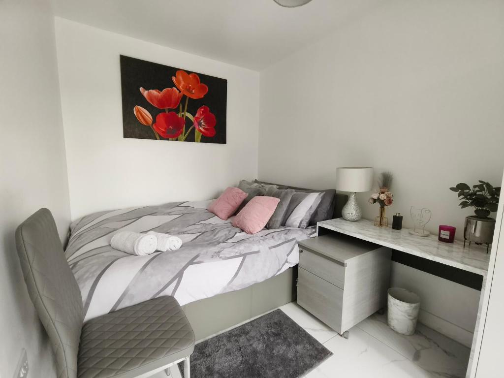 a white bedroom with a bed and a desk at Shared House - 10 mins from Piccadilly Station/Man Uni/O2 Apollo in Manchester