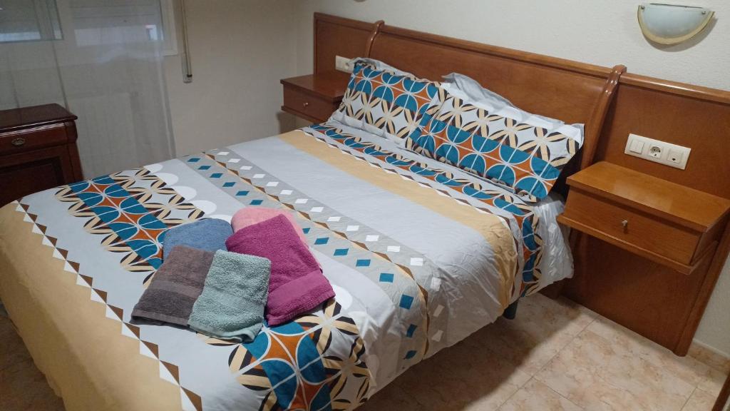 a bed with two pillows on it in a room at Alojamientos O Camiño in A Coruña