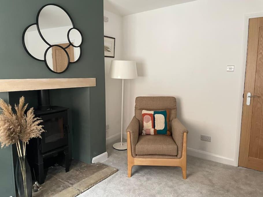 a living room with a chair and a mirror at 4@No.4. A cosy spot for 4 and one furry friend in Cawood