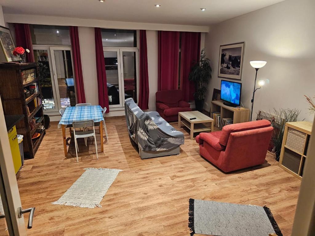 a living room with a couch and chairs and a table at Cosy apt à 200m de la Cathédrale in Liège