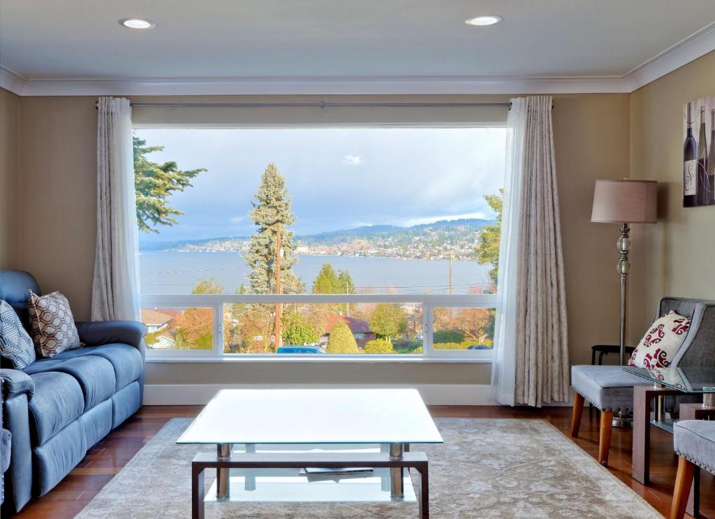 a living room with a large window at Mid-Century Seattle Home w/ Lakefront Views! in Seattle