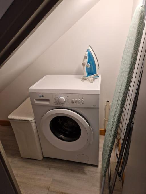 a washer and dryer in a room with a staircase at Chez Aurélie et Bruno in Montceau-les-Mines