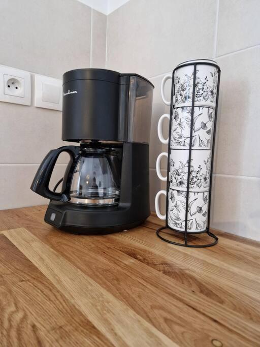 a black coffee maker sitting on a wooden counter at Chez Aurélie et Bruno in Montceau-les-Mines