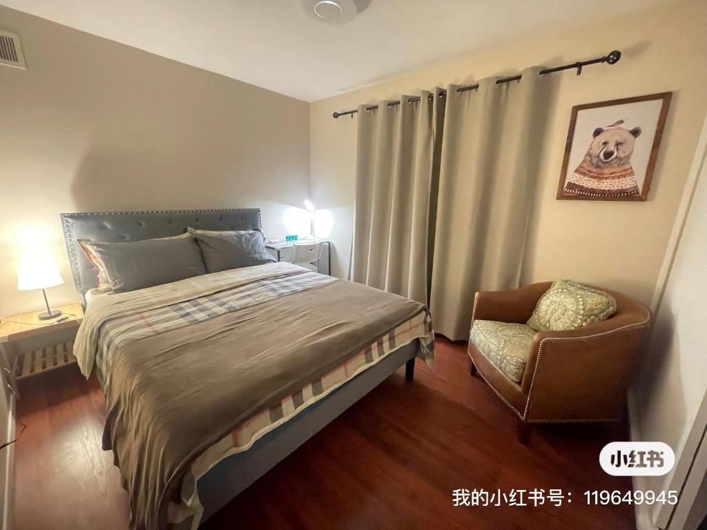 a bedroom with a large bed and a chair at Tao house in La Verne
