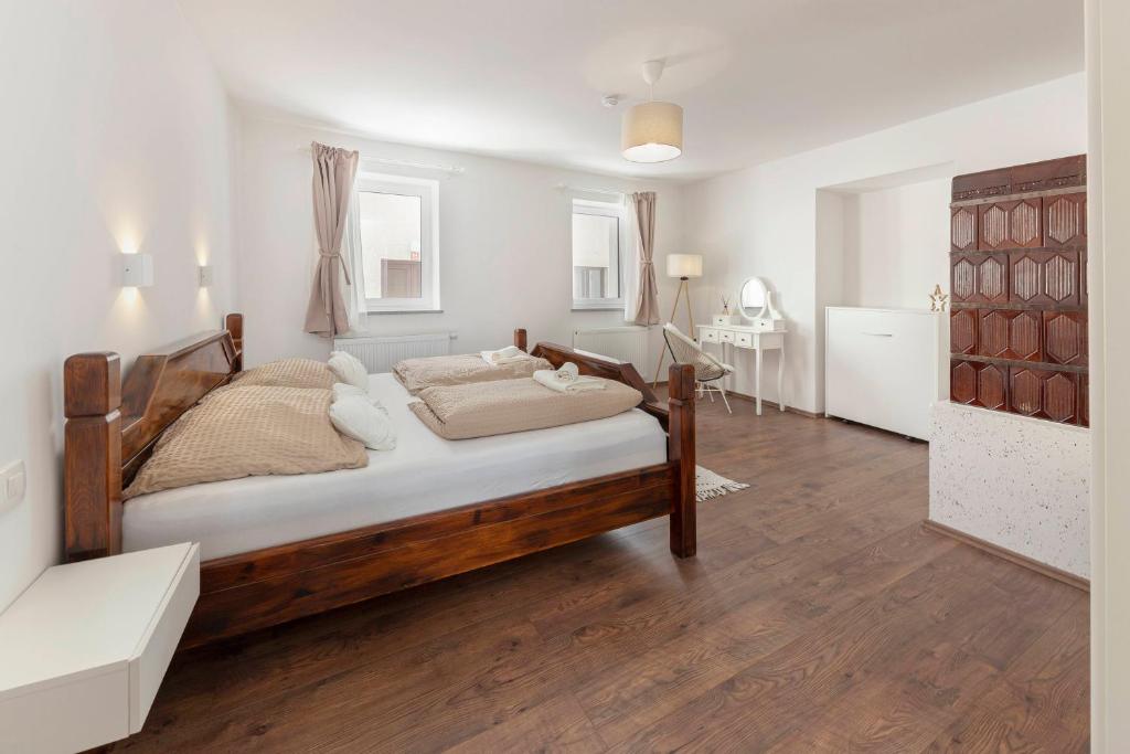 a bedroom with a wooden bed in a room at Deluxe Apartments 55 in Rateče