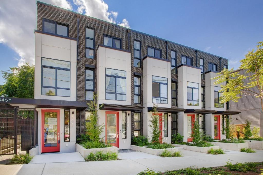 an apartment building with red doors at Gorgeous NEW Townhome on Capitol Hill, Close to Everything! in Seattle