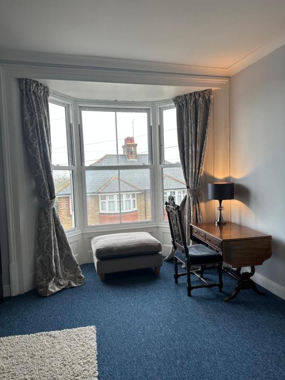 a room with a desk and a chair and a window at Stylish apartment in Walmer (nr Deal&Dover) in Walmer