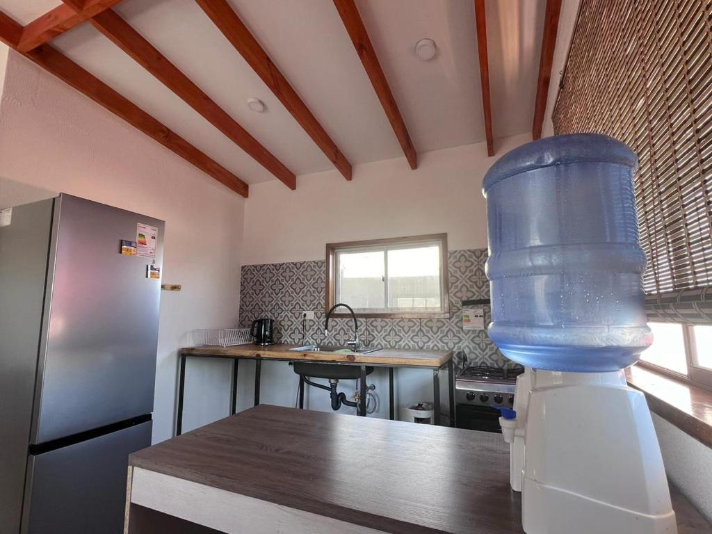 a kitchen with a large blue container on a table at Casa Playa Loreto in Caldera