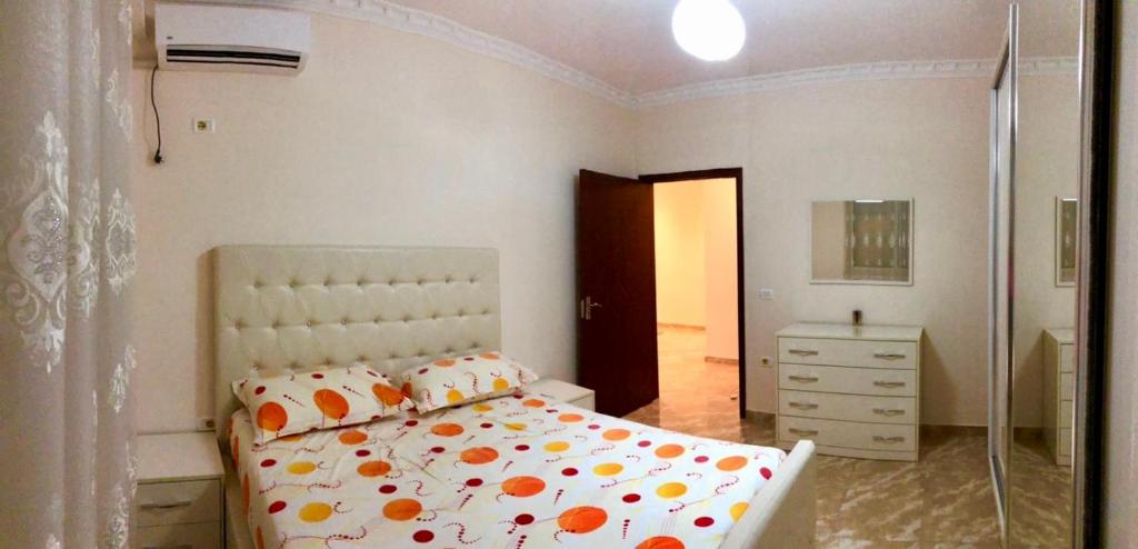 a bedroom with a bed and a walk in shower at Big apartment city center in Shkodër