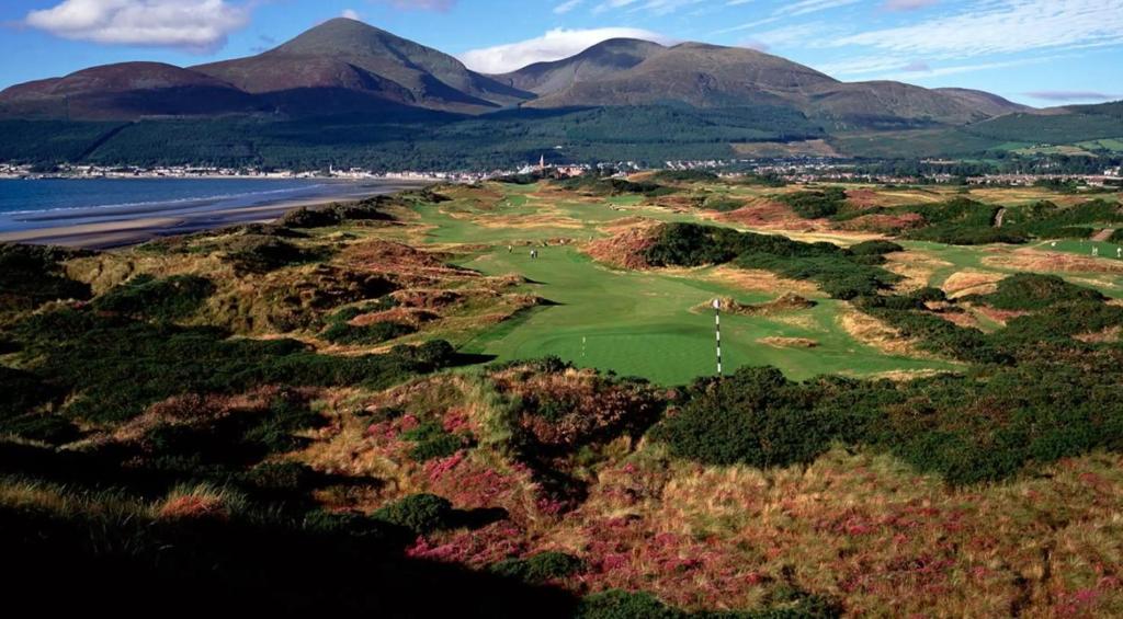 an aerial view of a golf course with mountains in the background at Park Avenue Apartment in Newcastle