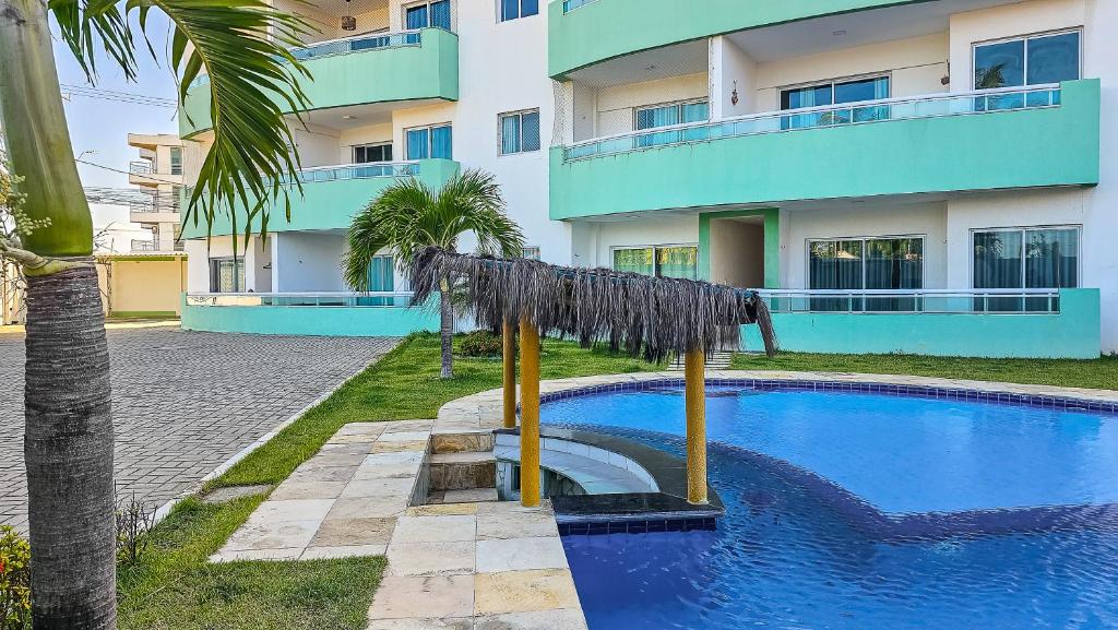 a swimming pool in front of a building at Aloha Vibes Ap Cumbuco - Green Club in Cumbuco