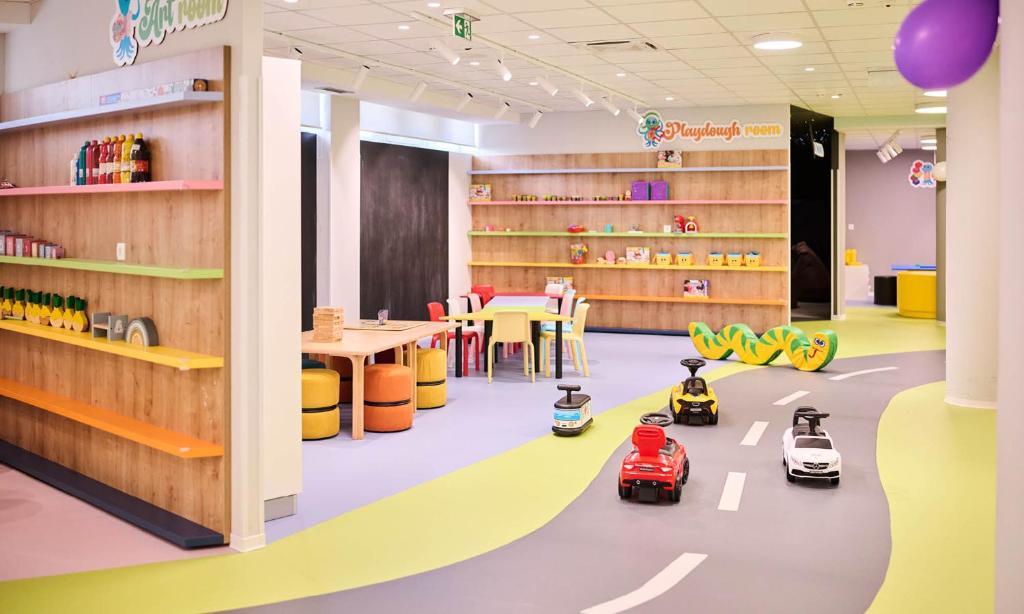 a library with toy cars on the floor at Aminess Vival Maestral Hotel in Novigrad Istria