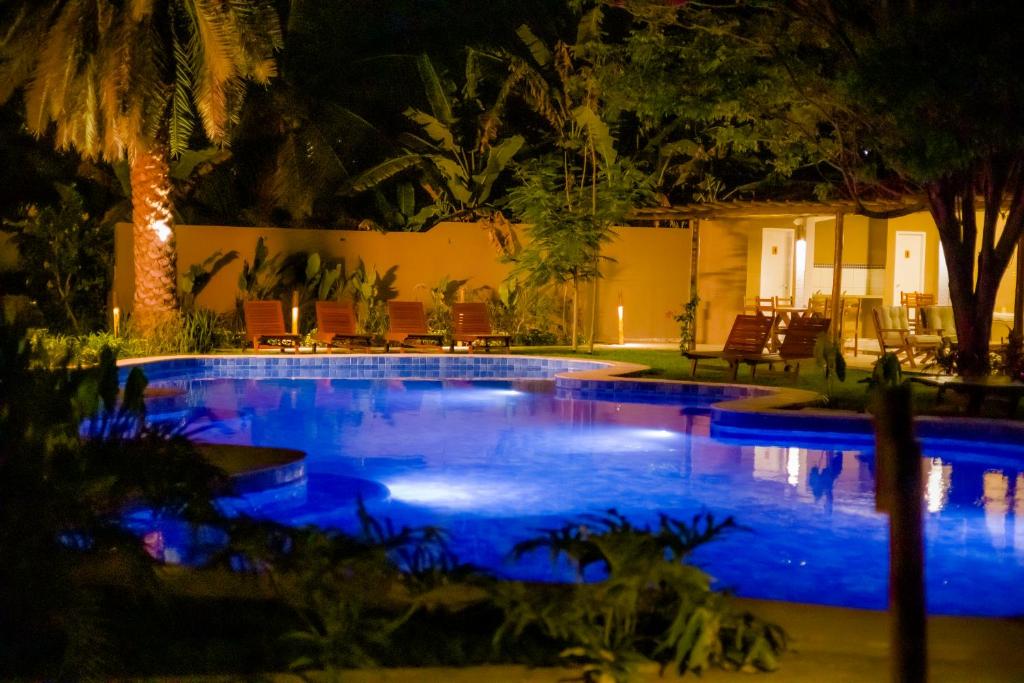 a swimming pool at night with blue lights at Villa Jaguar Fortim in Fortim
