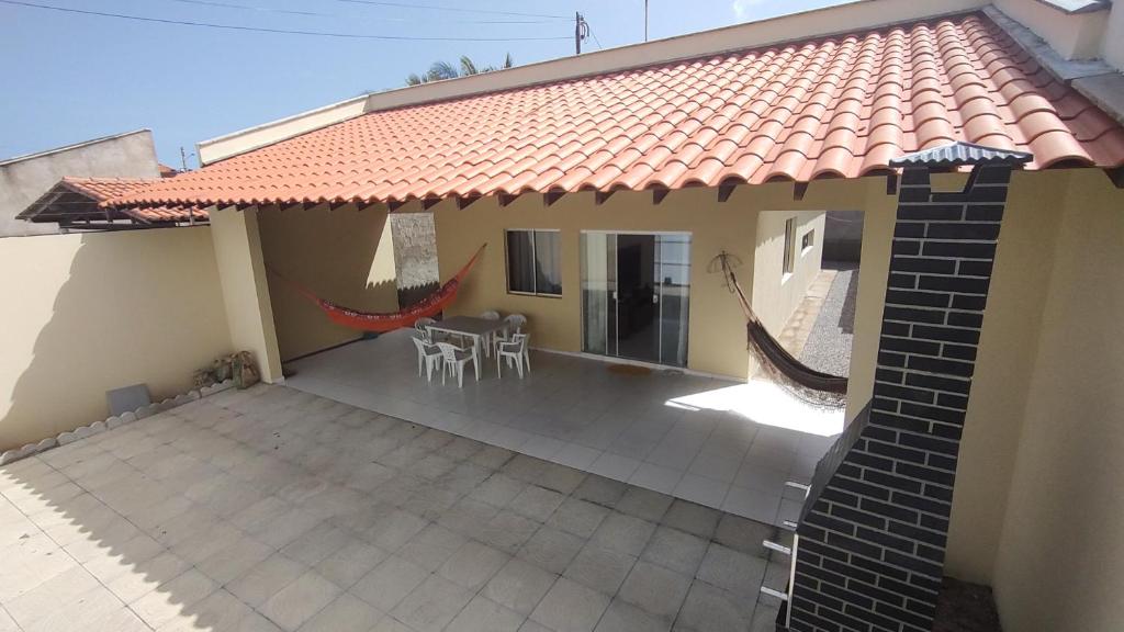 a house with a tile roof and a patio at Casa Caminho da Alvorada in Parnaíba