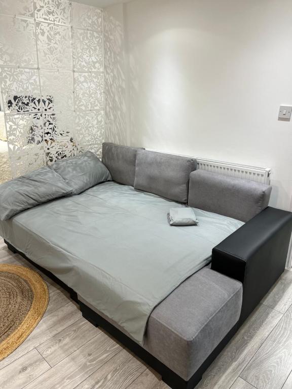 a large bed in a living room with at London charming bedroom flat in London