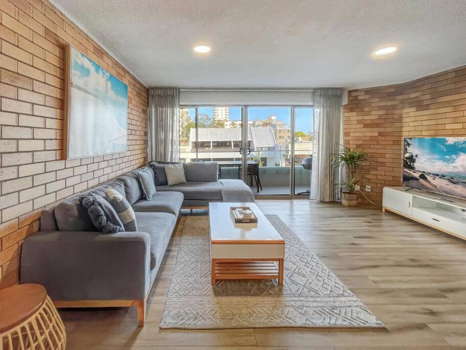 a living room with a couch and a tv at “The Block” Mooloolaba - Unit 3 in Mooloolaba