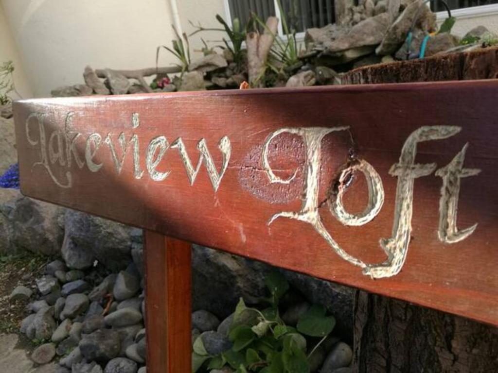 a wooden sign with the word happyride written on it at Amazing Lakeview Loft in Rotorua