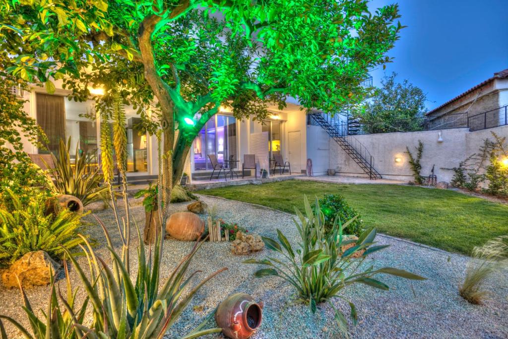 a garden with a tree and a house at 3SSS Bouquet Studios SEA in Marmarion
