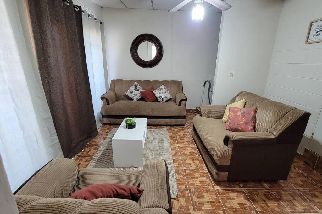 a living room with two couches and a table at Joya de Santa Ana, Apartamento privado completo in Santa Ana