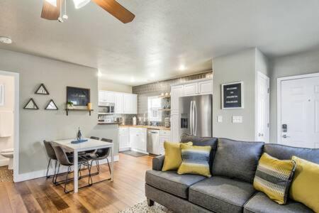 a living room with a couch and a kitchen at Vibrant Watermelon - Hot Tub, BBQ-Grill, King-Bed, Backyard, Parking in Colorado Springs