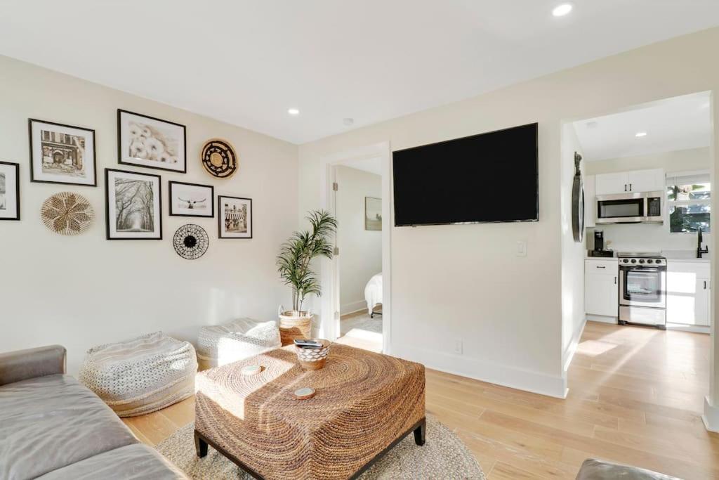 a living room with a couch and a table at Cottage on Croton Way # 2 in West Palm Beach