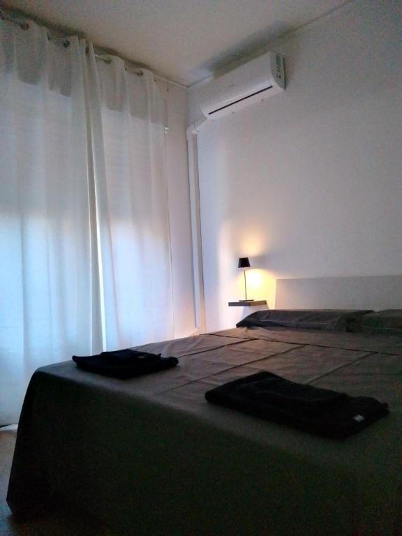 a bedroom with a bed and a window with a lamp at Red_Cross.Rent_Appartament in Palermo