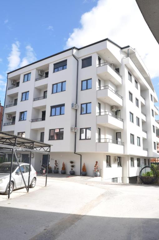 an apartment building with a car parked in front at Studio Sophia in Ohrid