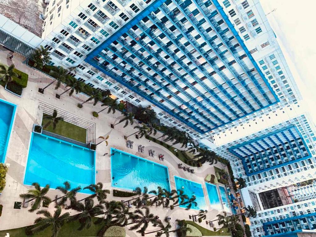 an overhead view of a large building with a pool at ARISE shell Residences in Manila
