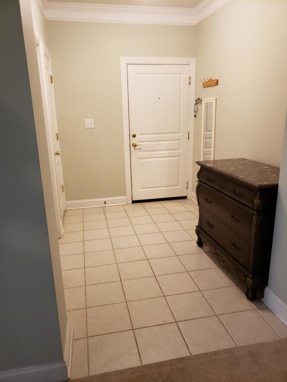 an empty room with a door and a tiled floor at Long Term Retreat Haven in Chapel Hill