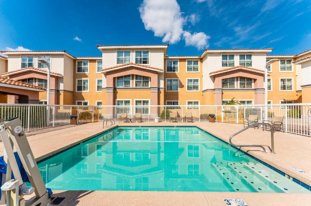 a swimming pool in front of a apartment building at Metro Scottsdale Promo 1 bd 1 in Scottsdale