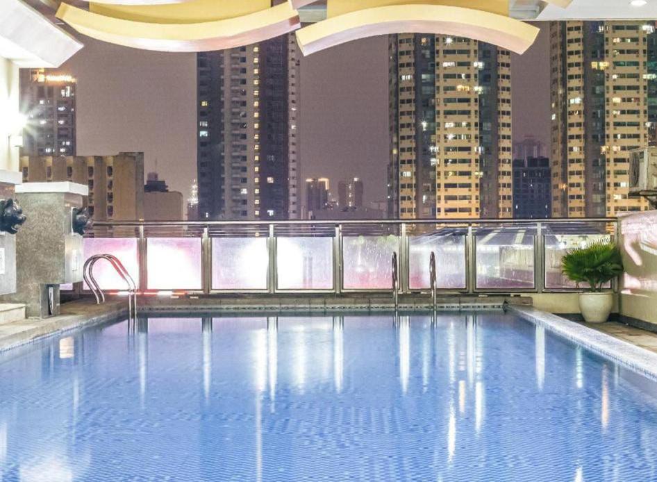 a large swimming pool on the roof of a building at Birchtower studio in Manila