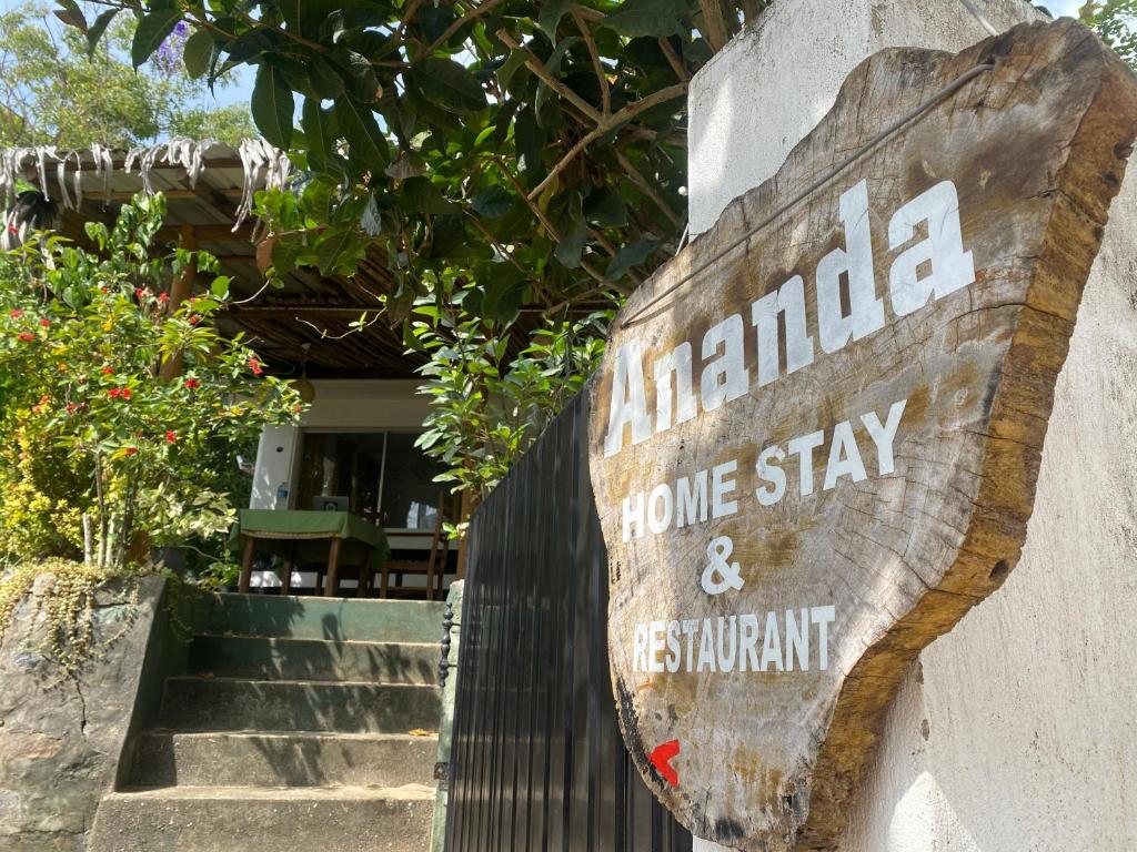 un cartel en la pared de una estancia en casa y un restaurante en Ananda Home Stay and Restaurant, en Tangalle