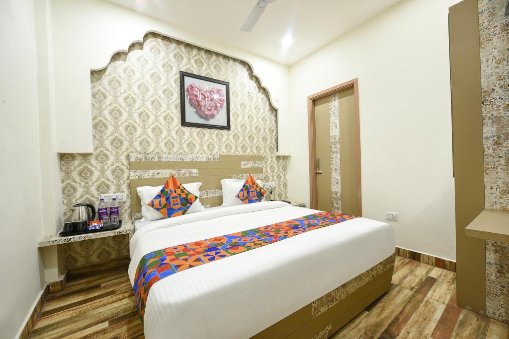 a bedroom with a large bed in a room at FabHotel Nirvana Grand By IO in Amritsar