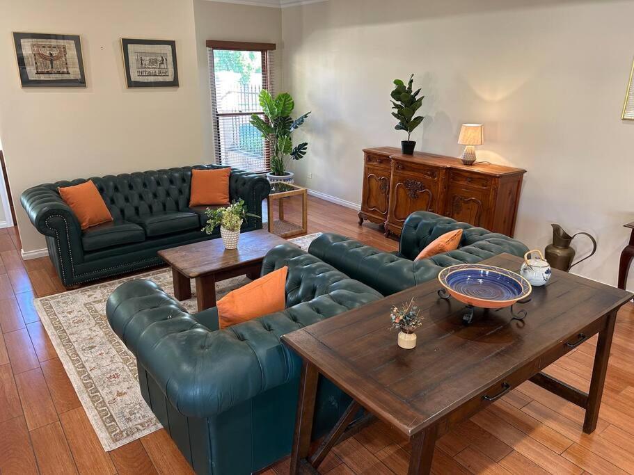 a living room with blue couches and a table at Grand retreat in peaceful street in Wodonga