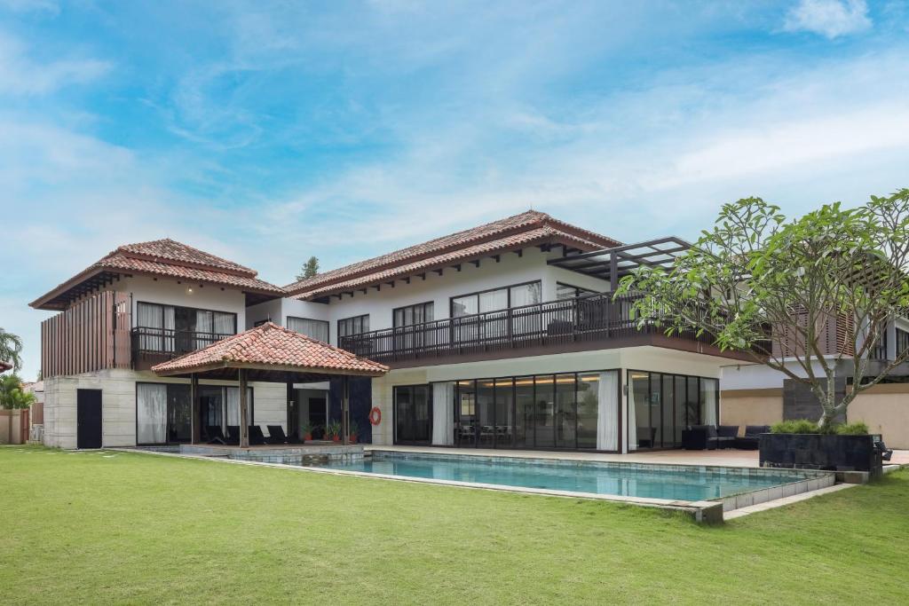 an exterior view of a house with a swimming pool at Pantai Indah Lagoi Bintan in Lagoi